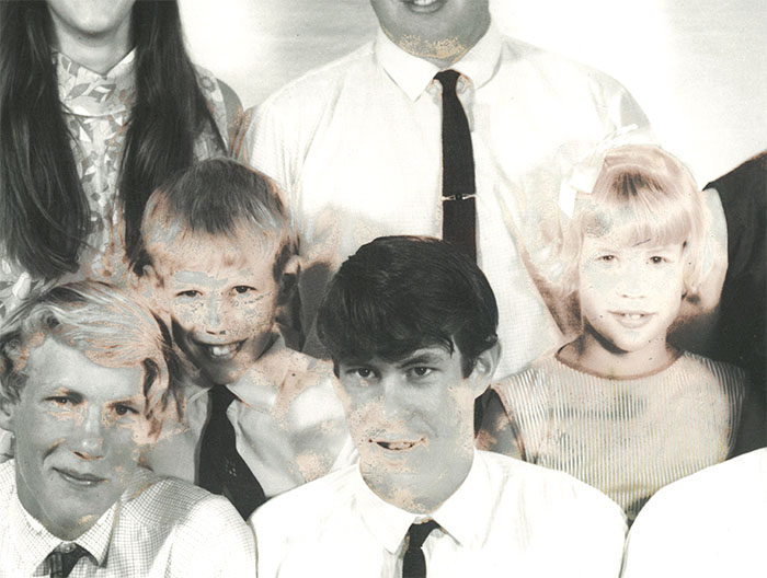 large photo with sun-damage to four faces comes in for photo restoration
