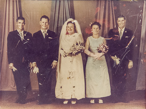 very marked and faded photo of bridal party comes in for restoring