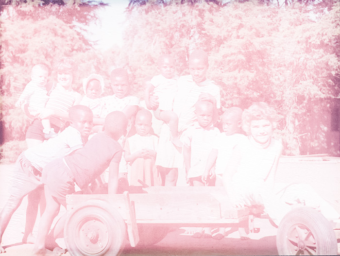disisntegrating pink photo from apartheid S Africa brought in for restoration