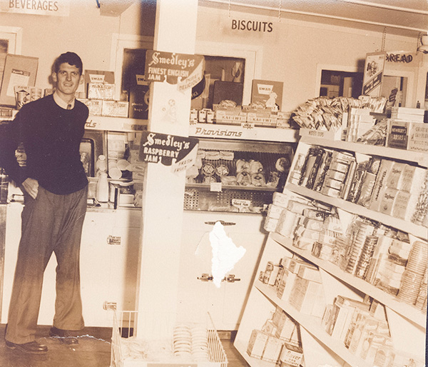 Restoration needed of faded Dad in photo of his family business