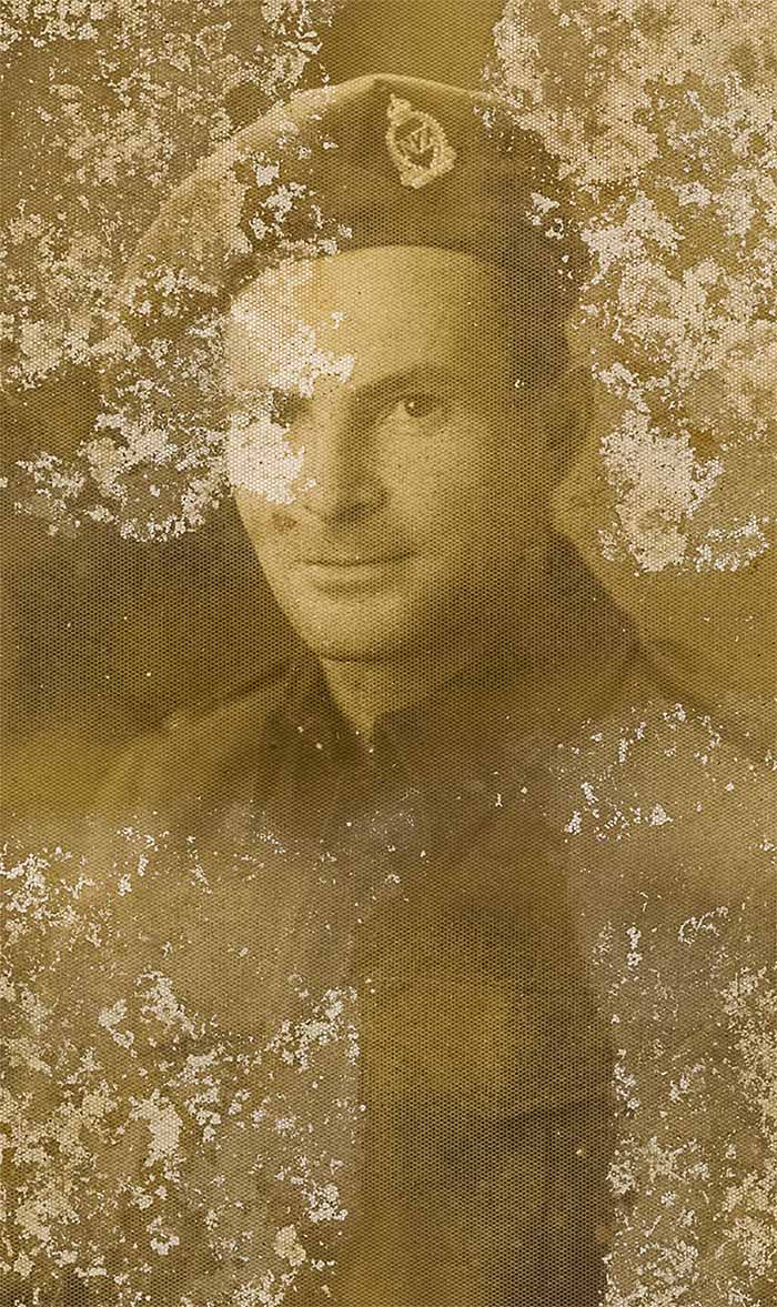 badly spoiled and yellowed photo of soldier as a young man needing repair andand textured